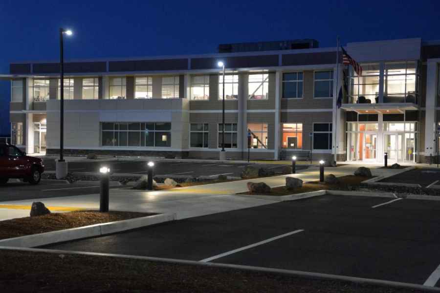Office Building With Lit Luminaires And Bollards At Night