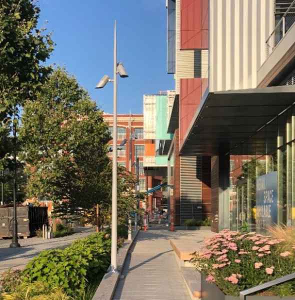 Pole On Walkway By Buildings