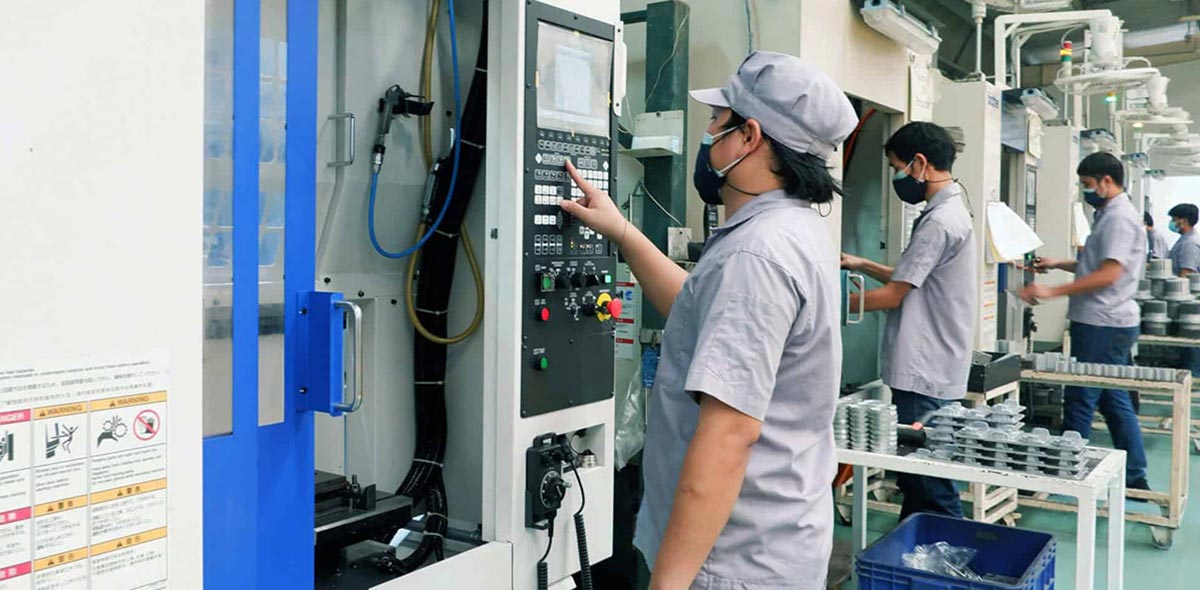 About World Class Fabrication Workers operating CNC machines in Ligman's manufacturing facility